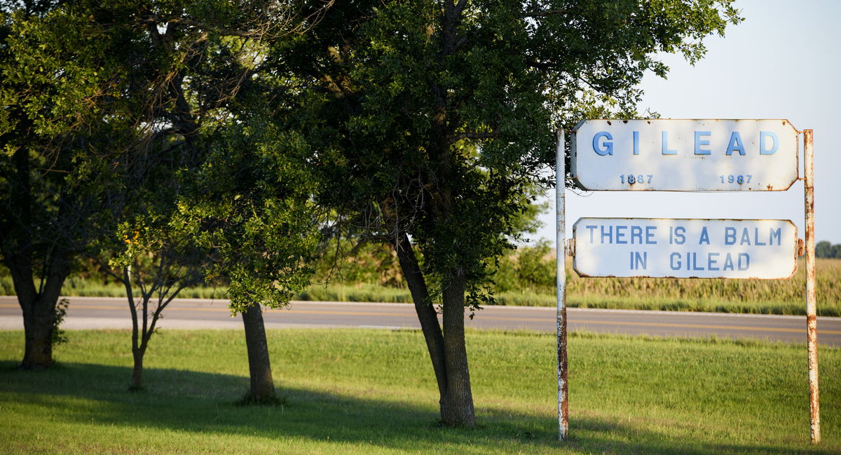 Roadside sign at the edge of Gilead, Nebraska reading: Gilead 1887&ndash;1987, There is a balm in Gilead